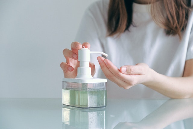 girl using sanitizer